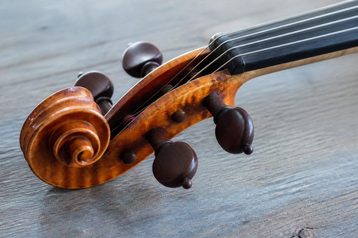 Close view of a maple violin scroll on a studio table